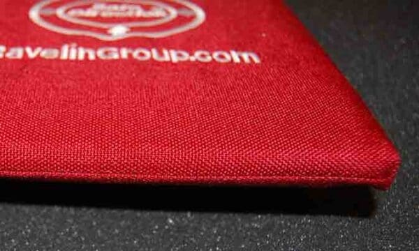 A close up of the logo on a red wallet.