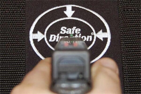 A person is aiming at the target with their gun.