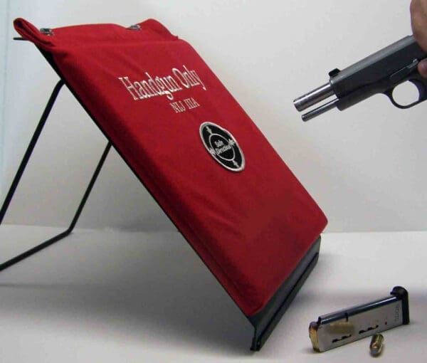 A red book with a gun on top of it