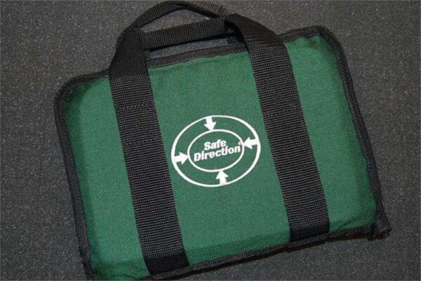 A green bag with black handles and a white logo.