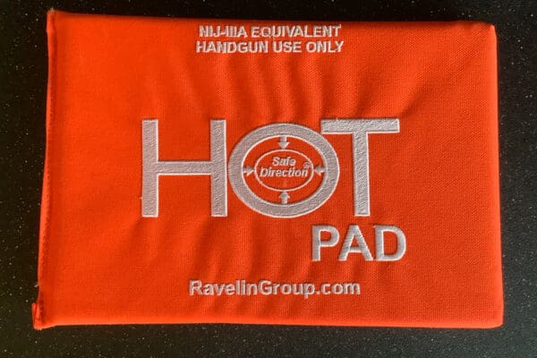 A red towel with the words " hot pad " written on it.