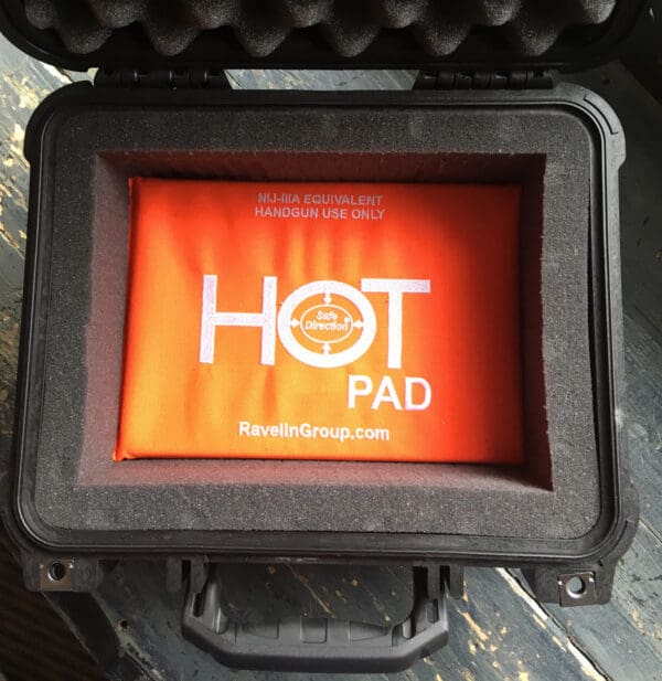 A black case with an orange screen and the words " hot pad ".